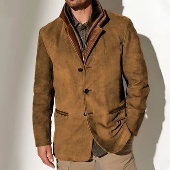 Men's olive green suede blazer with a classic collar and long sleeves, styled over a white dress shirt.