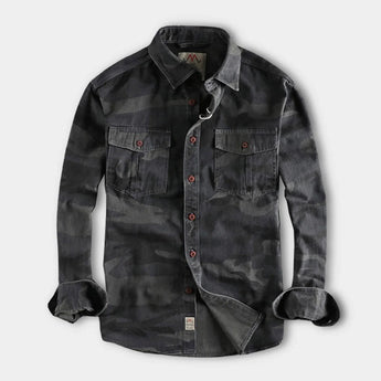 Men's durable military camo style jacket in green grey camouflage pattern, featuring a collared design with long sleeves, front buttons, and multiple pockets; size 3XL.