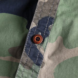 Men's military camo style jacket featuring a durable fabric with patterns of grey and beige, long sleeves, and a collared design ideal for tactical outerwear.