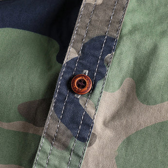 Men's military camo style jacket featuring a durable fabric with patterns of grey and beige, long sleeves, and a collared design ideal for tactical outerwear.