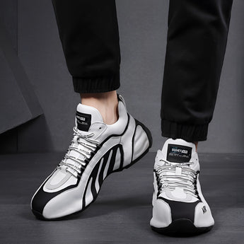 Men's fashionable futuristic design sneakers in black and grey, styled for urban athletic wear, shown on a person's feet.
