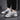 Men's fashionable futuristic design sneakers in a grey color with urban athletic styling, featuring a unique and modern look suitable for sportswear and outdoor activities.