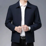 Men's formal dark blue slim fit blazer, styled with a dress shirt and showcasing a collar and sleeves; suitable for business wear.