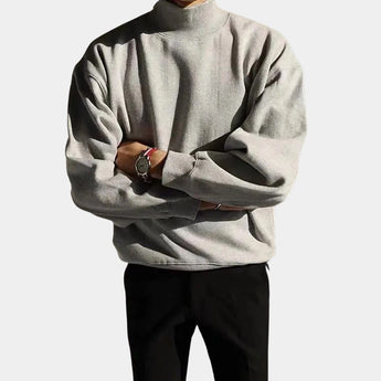 Men's gray casual turtleneck sweater made from a cotton-blend fabric, featuring a pocket and long sleeves, with a cozy collar design.
