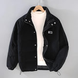 Men's black corduroy insulated winter jacket with a high collar and button details, urban style, featuring long sleeves and a cozy design suitable for cold weather.