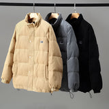 Men's grey corduroy insulated winter jacket featuring a high collar and urban style design, showcasing a blend of natural and composite materials with a fashionable look.