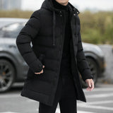 Men's black hooded insulated parka, long puffer winter coat with grey accents, worn by a person standing.
