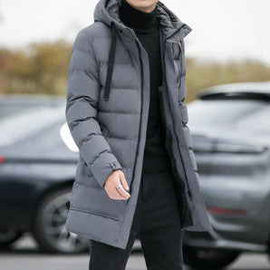 Men's grey hooded insulated parka, long puffer winter coat, displayed in size 4XL, featuring a hood and long sleeves against a background with a black vehicle and visible car tire.