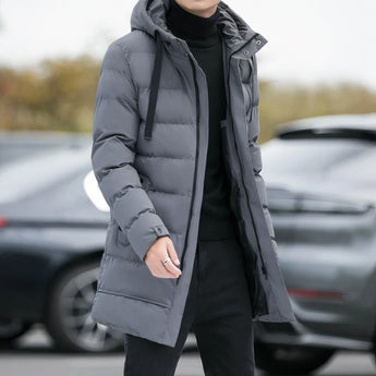 Men's grey hooded insulated parka, long puffer winter coat, displayed in size 4XL, featuring a hood and long sleeves against a background with a black vehicle and visible car tire.