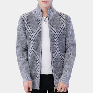 Men's grey knit bomber jacket in a geometric wool design featuring a zip-up front, with a collar and long sleeves, suitable for winter fashion.