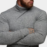 Men's grey knit turtleneck sweater in a fitted muscle fit style, showcasing the texture and design details of the fabric, with focus on the neck and shoulder areas.