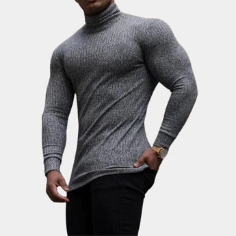 Men's fitted muscle fit grey knit turtleneck sweater featuring long sleeves and a ribbed neck, shown on a model showcasing the sweater's tailored fit.