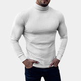 Men's grey knit turtleneck sweater in a fitted muscle fit style, worn by a model with a beard, showcasing the sweater's snug fit on the shoulders and arms, emphasizing the muscular physique.