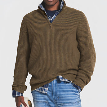 Men's grey ribbed half-zip sweater featuring a high collar and long sleeves, styled with denim jeans, ideal for fall and winter wear.