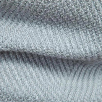 Men's grey ribbed knit crew neck sweater with striped pattern, featuring long sleeves and woolen texture, displayed against a denim background.
