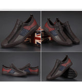 Men's grey slip-on sneakers featuring red accents, photographed against a plain background, showcasing their stylish and comfortable design.