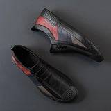 Men's grey slip-on sneakers with red accents, featuring a sleek and stylish design, showcasing synthetic rubber material for added comfort and durability.