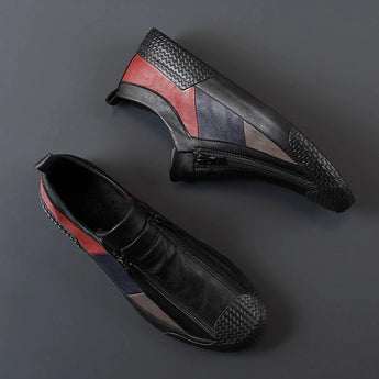 Men's grey slip-on sneakers with red accents, featuring a sleek and stylish design, showcasing synthetic rubber material for added comfort and durability.