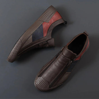Men's grey slip-on sneakers featuring red accents, showcasing a sleek and comfortable design ideal for casual wear.