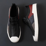 Men's grey slip-on sneakers with red accents, showcasing a stylish and comfortable design, perfect for casual wear and outdoor activities.