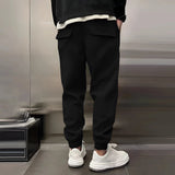 Men's grey tapered fleece joggers with zip pockets being worn, highlighting the comfortable fit and style.