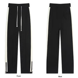 Men's grey tapered joggers featuring two-tone stripes on the sides, with pockets and ankle cuffs.