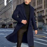 Men's grey wool winter coat displayed on a mannequin, showcasing its stylish urban fashion design with a tailored fit, long sleeves, and a classic collar, set in an indoor environment with a window in the background.