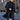 Men's grey wool winter coat displayed on a mannequin, showcasing its stylish urban fashion design with a tailored fit, long sleeves, and a classic collar, set in an indoor environment with a window in the background.