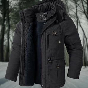 Men's heavy-duty insulated winter parka in black, featuring a hood, water-resistant material, long sleeves, and thermal insulation, shown in a snowy outdoor setting.