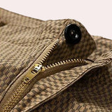 Men's khaki herringbone summer shorts made from breathable cotton with a casual fit, displayed on a wooden surface.