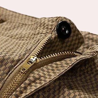 Men's khaki herringbone summer shorts made from breathable cotton with a casual fit, displayed on a wooden surface.