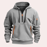 Men's gray tactical hoodie featuring zipper pockets, reinforced elbows, and a comfortable jersey material, showcasing its functional design with a focus on the shoulder, neck, and sleeves.