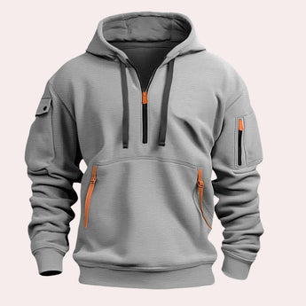 Men's gray tactical hoodie featuring zipper pockets, reinforced elbows, and a comfortable jersey material, showcasing its functional design with a focus on the shoulder, neck, and sleeves.