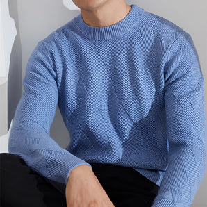 Men's light blue cable knit crew neck sweater with long sleeves, featuring a cozy and stylish design suitable for winter fashion.