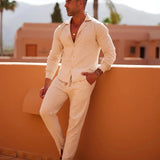 Men wearing lightweight beige linen pants, styled for summer fashion and resort wear. The outfit includes a dress shirt and eyewear, with a focus on casual, comfortable elegance.