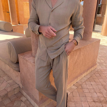 Men wearing lightweight beige linen pants suitable for summer fashion and resort wear, paired with a dress shirt and blazer.
