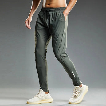 Men's green lightweight jogger pants with zipper pockets and adjustable waist, size 3XL, shown being worn to showcase fit and style.