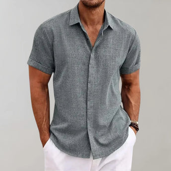Men's gray linen Henley short sleeve shirt in size 3XL, featuring a casual yet stylish design with a breathable fabric. The shirt has a collar and is complemented by a model wearing a watch, with focus on the details like the sleeve and waist area.