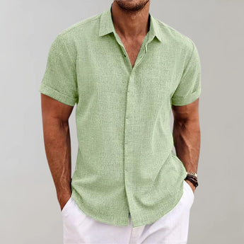 Men's linen henley short sleeve shirt in yellow-green, size 3XL, featuring a breathable and casual design suitable for summer. The shirt has a collar and a buttoned neckline, with sleeves reaching just above the elbow. The model is wearing a watch on one arm.
