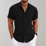 Men's black linen Henley short sleeve shirt in size 3XL, featuring a breathable and casual design. The shirt is being worn, showcasing the arm, neck, and sleeve details.