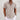 Men's white linen short sleeve button-up shirt featuring a lightweight and breathable fabric, shown on a model with arms relaxed, highlighting the shoulder and waist fit.