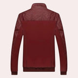 Men's luxury burgundy leather jacket with quilted design and tailored fit, featuring a stylish collar and sleek sleeves, displayed on a clothes hanger.