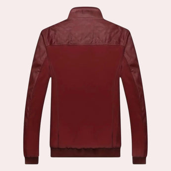 Men's luxury burgundy leather jacket with quilted design and tailored fit, featuring a stylish collar and sleek sleeves, displayed on a clothes hanger.