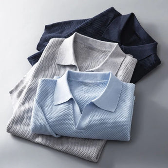 Men's luxury knit polo shirt in electric blue with a stylish pattern, featuring a classic collar and short sleeves.
