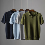 Men's luxury knit polo shirt in a stylish grey color, featuring short sleeves and a collared neckline. The shirt is displayed on a clothes hanger, emphasizing its breathable and high-quality composite material.