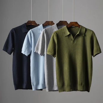 Men's luxury knit polo shirt in a stylish grey color, featuring short sleeves and a collared neckline. The shirt is displayed on a clothes hanger, emphasizing its breathable and high-quality composite material.
