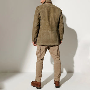 Men's luxury olive suede blazer with tailored fit, featuring a classic collar and structured shoulders, styled with a beige dress shirt underneath.