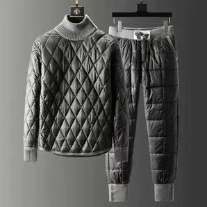 Men's black luxury quilted insulated tracksuit with a focus on the shoulder and sleeve design, featuring a collar and a hint of tartan pattern, designed for winter athleisure wear.