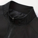 Men's minimalist black bomber jacket featuring a sleek design with a front zipper, ribbed cuffs, and collar, paired with blue jeans.