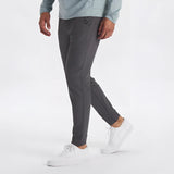 Light grey men's moisture-wicking quick-dry athletic t-shirt worn with jeans.